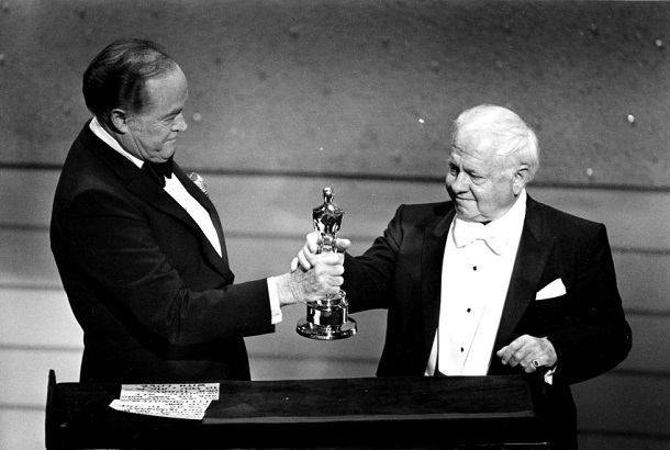 Entertainer Bob Hope, left, presents the Honorary Oscar for Lifetime Achievement to actor Mickey Rooney at the 55th Annual Academy Awards ceremony in Los Angeles, Ca., April 10, 1983.  Rooney is honored for his 60 years of contribution to the motion picture industry.  (AP Photo)